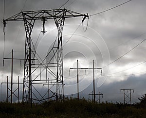 Power lines on a gray sky with mountains