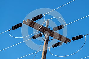 Power lines and insulators with a clear blue sky