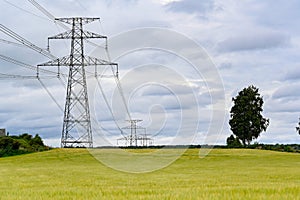 Power lines over fields a cloudy summers day