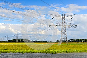 Power lines and pylons in a colorful Dutch polder landscape