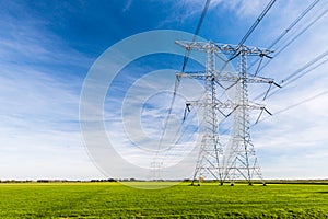 Power lines and pylons in a rural landscape