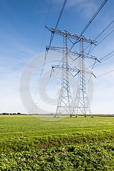 Power lines and pylons in a rural landscape