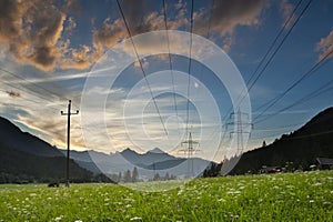 Power lines and pylons at sunset