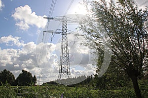 Power lines on a tower in the sunlight at park Hitland in Nieuwerkerk aan den Ijssel in the Netherlands photo