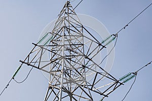 Power lines and towers - a modern high voltage power system. Against the background of the blue sky