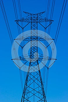 Power lines towers sky background