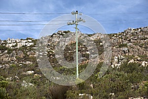 Power lines travel over a mountain South Africa