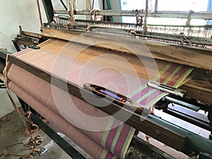 Power loom equipment weaving sarees by using wefts and plaiting using thousands of warps and this weaving industry running in