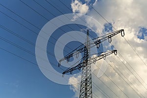 A power mast below a blue sky