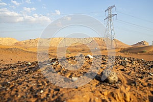 Power mast in the desert. Some mountains in the background