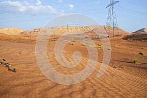 Power mast in the desert. Some mountains in the background