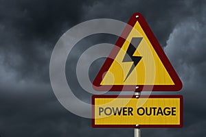Power Outage message on warning road sign with stormy sky photo