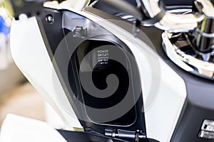 Power outlet for charger mobilephone on a modern motorcycle,Close up and selective focus