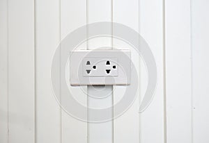 Power outlet on white wall background