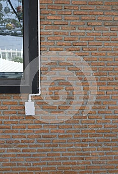 Power outlets on the brick wall vertical orientation.