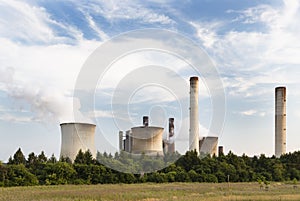 Power Plant Behind Field And Trees