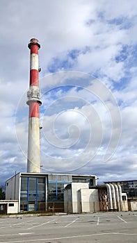 Power plant building with high industrial chimney