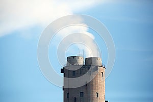 Power plant chimney with smokes