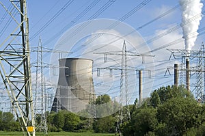 Power plant and electricity pylons between trees