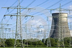 Power plant and electricity pylons between trees photo