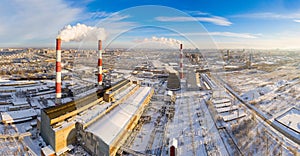 Power plant pipes on the background of the panorama of the winter city against blue sky