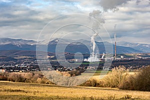 Power plant in Slovakia seen in distance surrounded by nature and small town