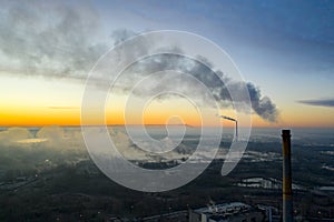 Power plant smokestack at sunrise. Environmental pollution