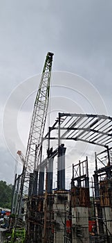 power plant structure construction process using crane rainy cloud