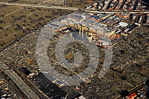 A power plant is surrounded by acres of cemeteries