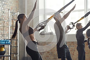 Power Play. Portrait of man and women doing fitness training exercises at industrial gym. Push-up, group workout concept