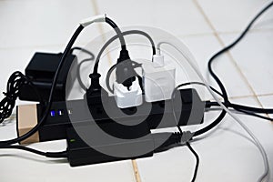 Power plug in full , power outlet multiple socket - overload charger extension cord cable connector photo