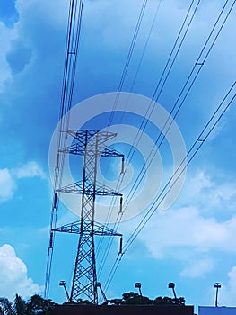 power pole and electrical wires against a blue sky
