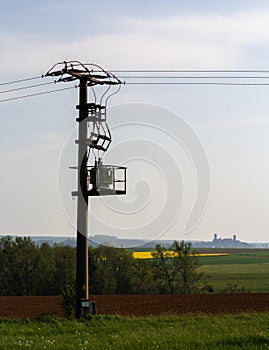 Power pole in the field, with Muenzenberg Castle in the background