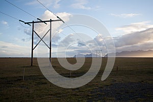 Power pole with sunset in Iceland. Light and shadow over the lan