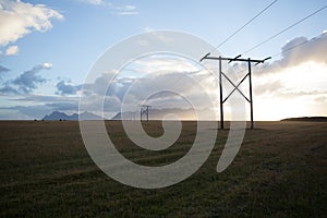 Power pole with sunset in Iceland. Light and shadow over the lan