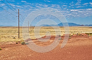 A Line of Power Poles in the Desert near Winslow, Arizona photo