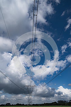 Power pylons and high voltage lines in an agricultural landscape in Europe.