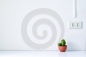 Power saving concept, plug on the electric socket on white wall.