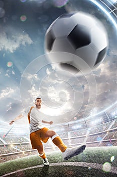 Power soccer kick. A soccer player kicks the ball in stadium. Professional soccer player in action. Wide angle. Vertical