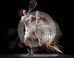 Power and speed. Young man, professional tennis player in motion and action isolated on dark background with stroboscope