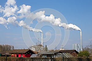 Power station with chimneys and white smoke
