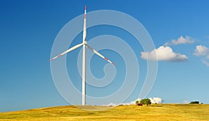 Power station for renewable electric energy production. Windmill on sunny summer day. High wind turbine for generation electricity