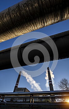 Power station smoking chimney with district heating tubes
