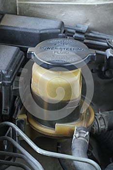 Power steering fluid reserve bottle