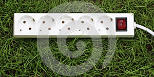 An power strip lying on the grass