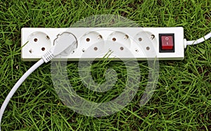 An power strip lying on the grass