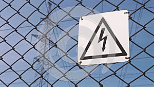 Power substation. Warning sign about the risk of electric shock. High-voltage wires on the support, production and
