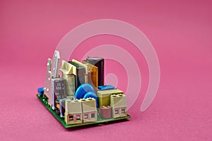 Power supply Board on pink background,. Printed circuit board PCB