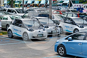 Power supply connects to plug-in electric vehicle or electric car at charging kiosk in car park in Sun Moon Lake area