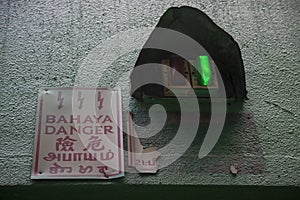 Power supply room indicator lights with sign stated `Danger` from the language of Malay, English, Chinese, Punjabi & Tamil photo